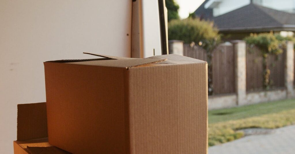 View inside a delivery van with stacked cardboard boxes ready for moving.